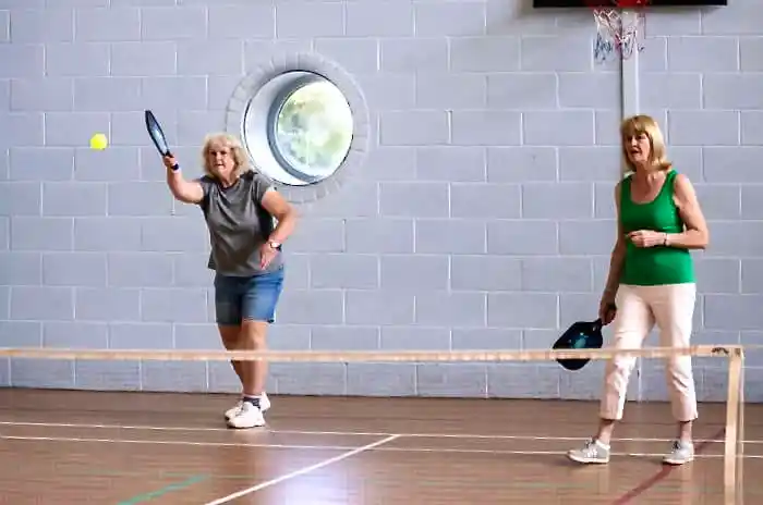 two ladies playing pickleball