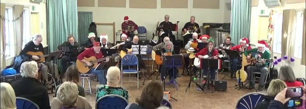 Guitars + performing at a Christmas concert in front of an audience.