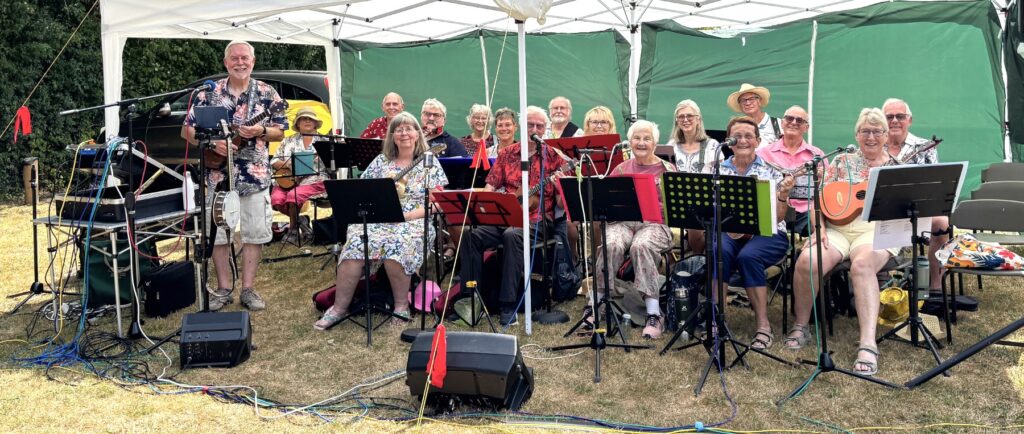 Riverblue - Verwood u3a Ukulele Group performing in a marquee at a ukulele picnic